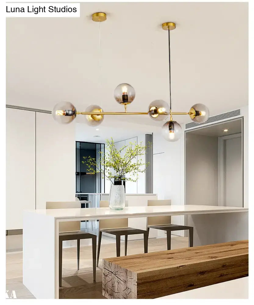Modern gold island pendant light with glass globes for dining room