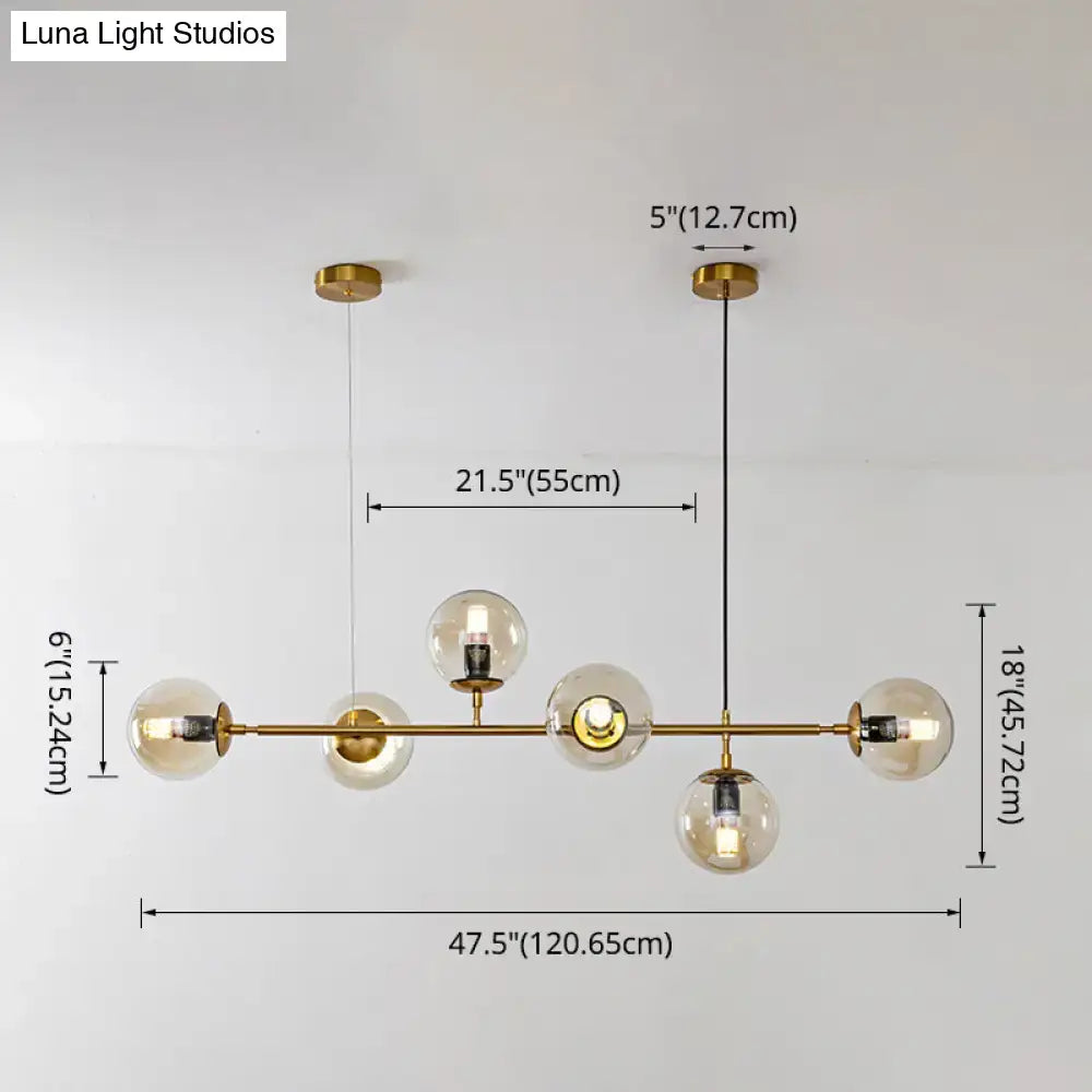 Modern gold island pendant light with glass globes for dining room
