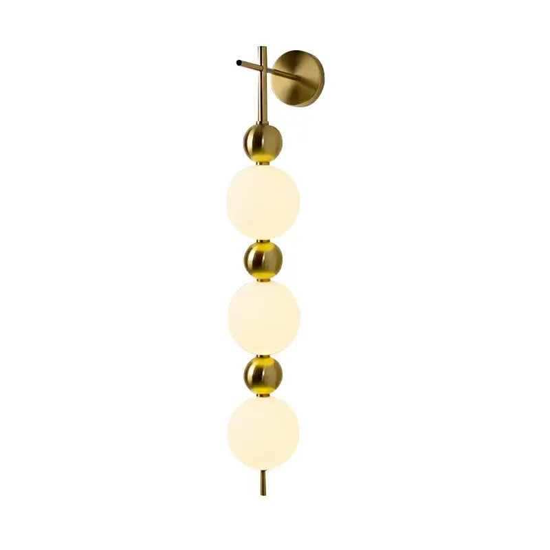 Modern gold led wall sconce with frosted glass spheres for bedroom
