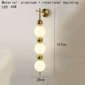 Modern gold led wall sconce with frosted glass spheres for bedroom
