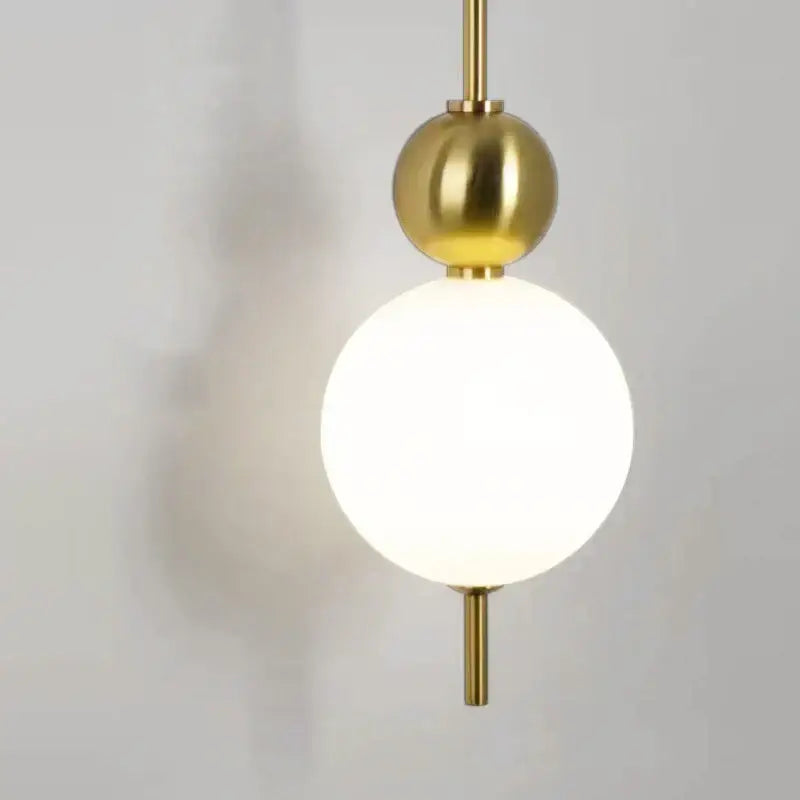 Modern gold led wall sconce with frosted glass spheres for bedroom