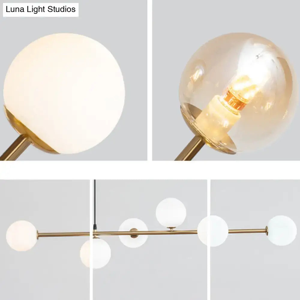 Modern gold metal island pendant with blue glass spheres dining room