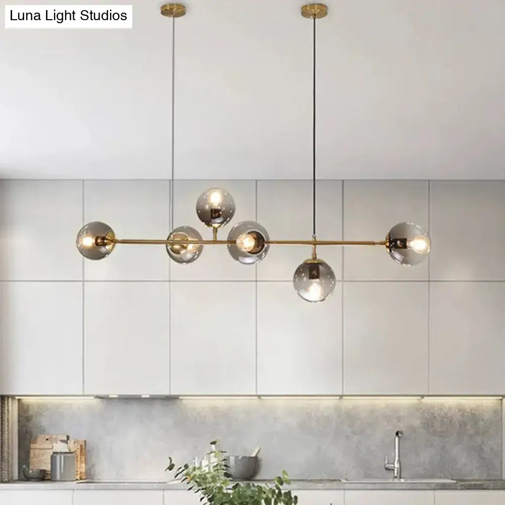Modern gold metal island pendant with blue glass spheres dining room