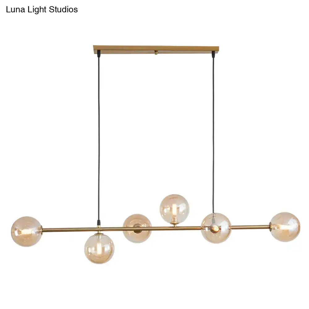 Modern gold metal island pendant with blue glass spheres dining room