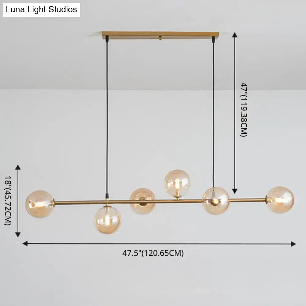 Modern gold metal island pendant with blue glass spheres dining room