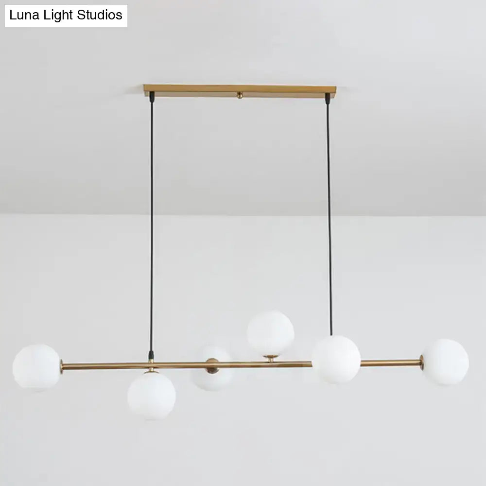 Modern gold metal island pendant with blue glass spheres dining room