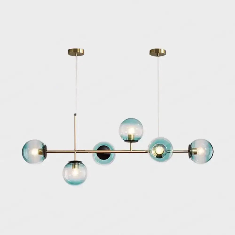 Modern gold metal island pendant with blue glass spheres dining room