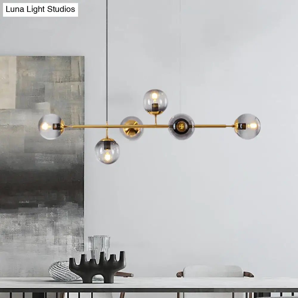 Modern gold metal island pendant with blue glass spheres dining room