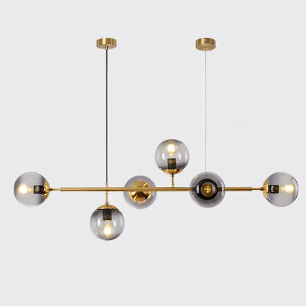 Modern gold metal island pendant with blue glass spheres dining room