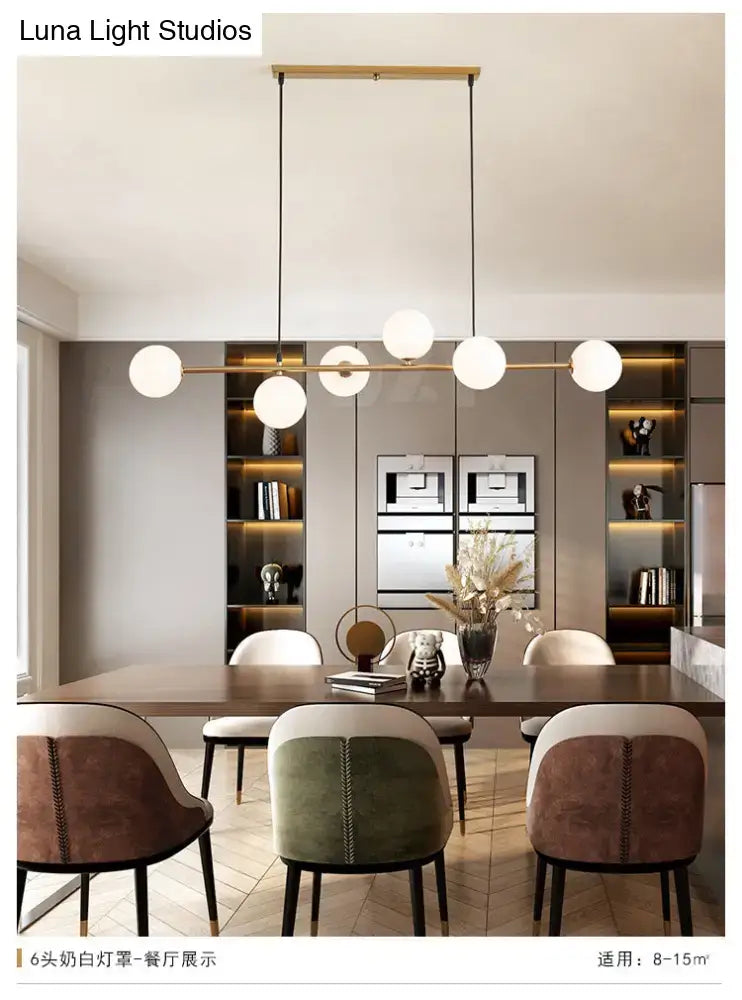 Modern gold metal island pendant with blue glass spheres dining room