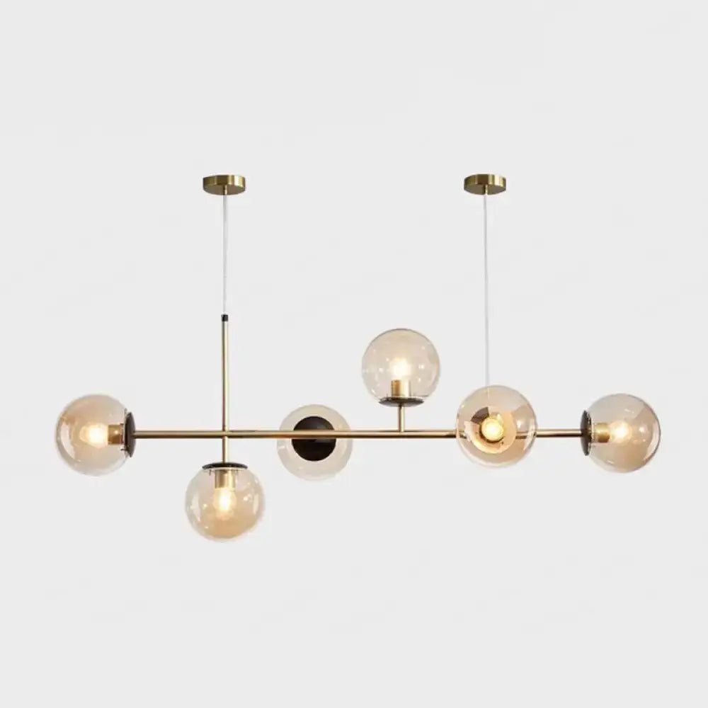 Modern gold metal island pendant with blue glass spheres dining room