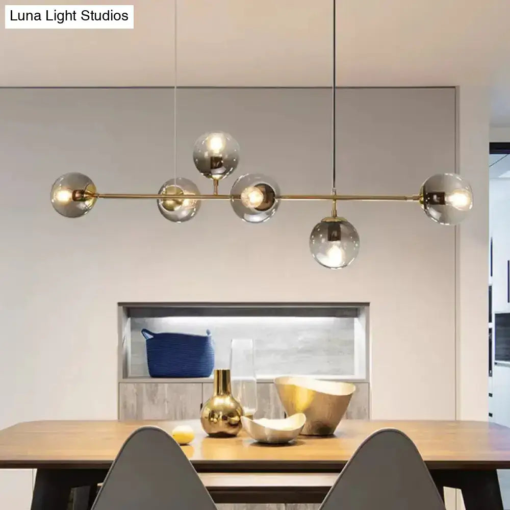 Modern gold metal island pendant with blue glass spheres dining room