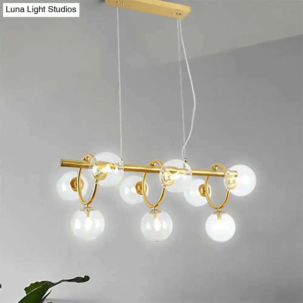 Modern gold pendant light with clear cognac glass for dining room