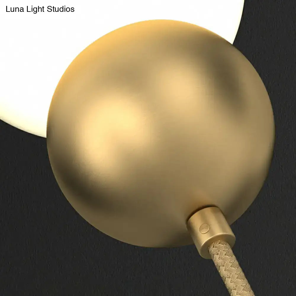 Modern gold sconce light with milky glass – bedroom wall lamp