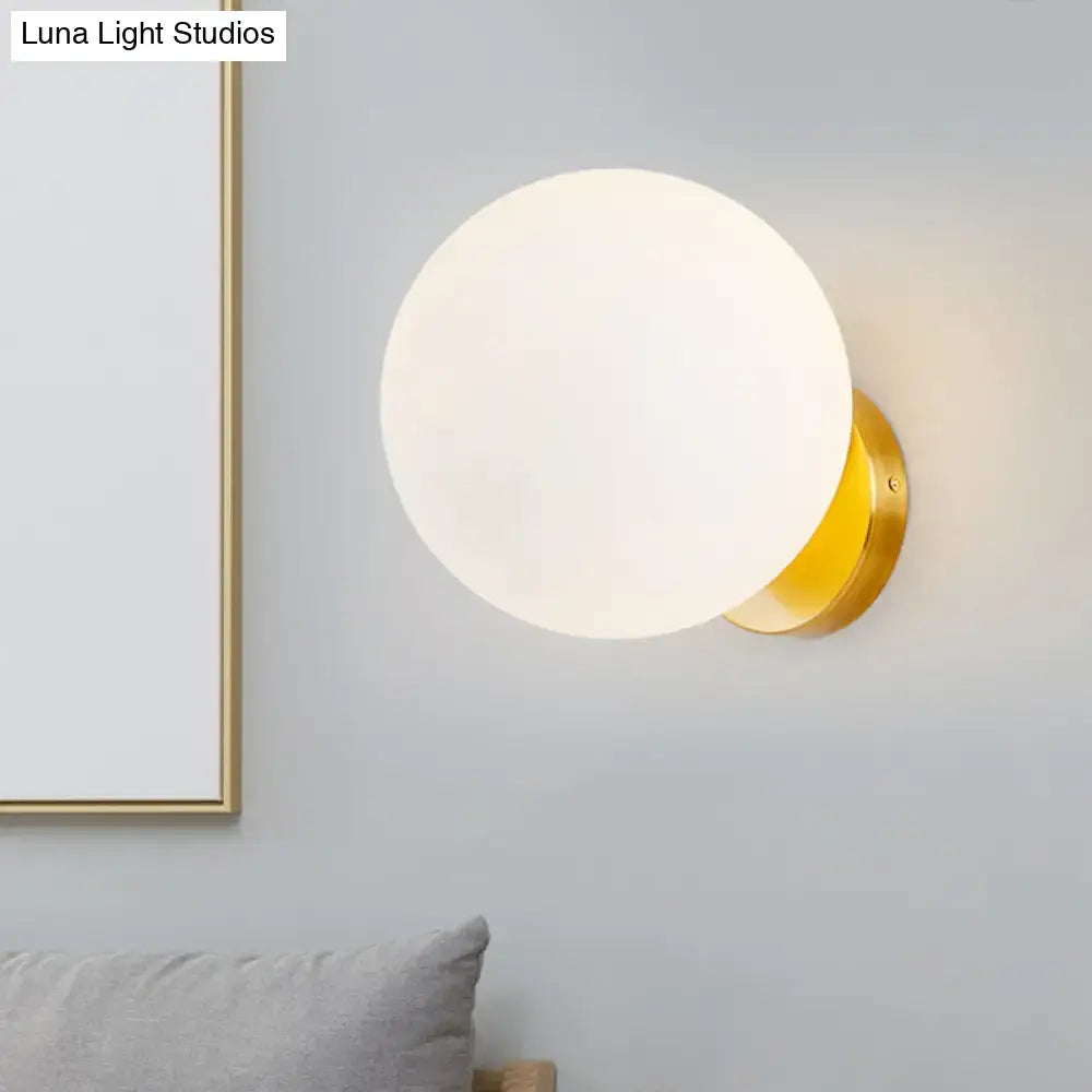 Modern gold wall lamp with opal glass shade bedroom light