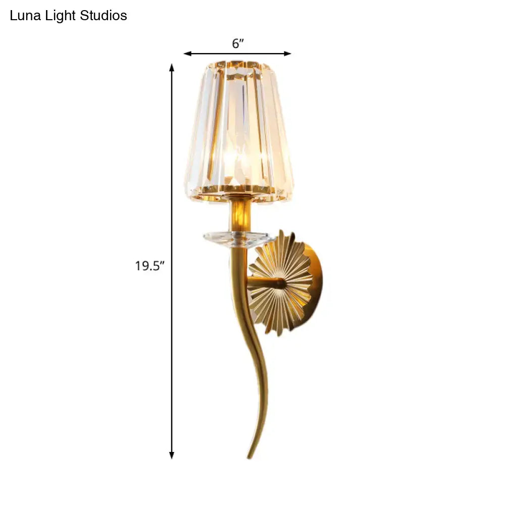 Modern gold wall light with clear tapered shade for stairways
