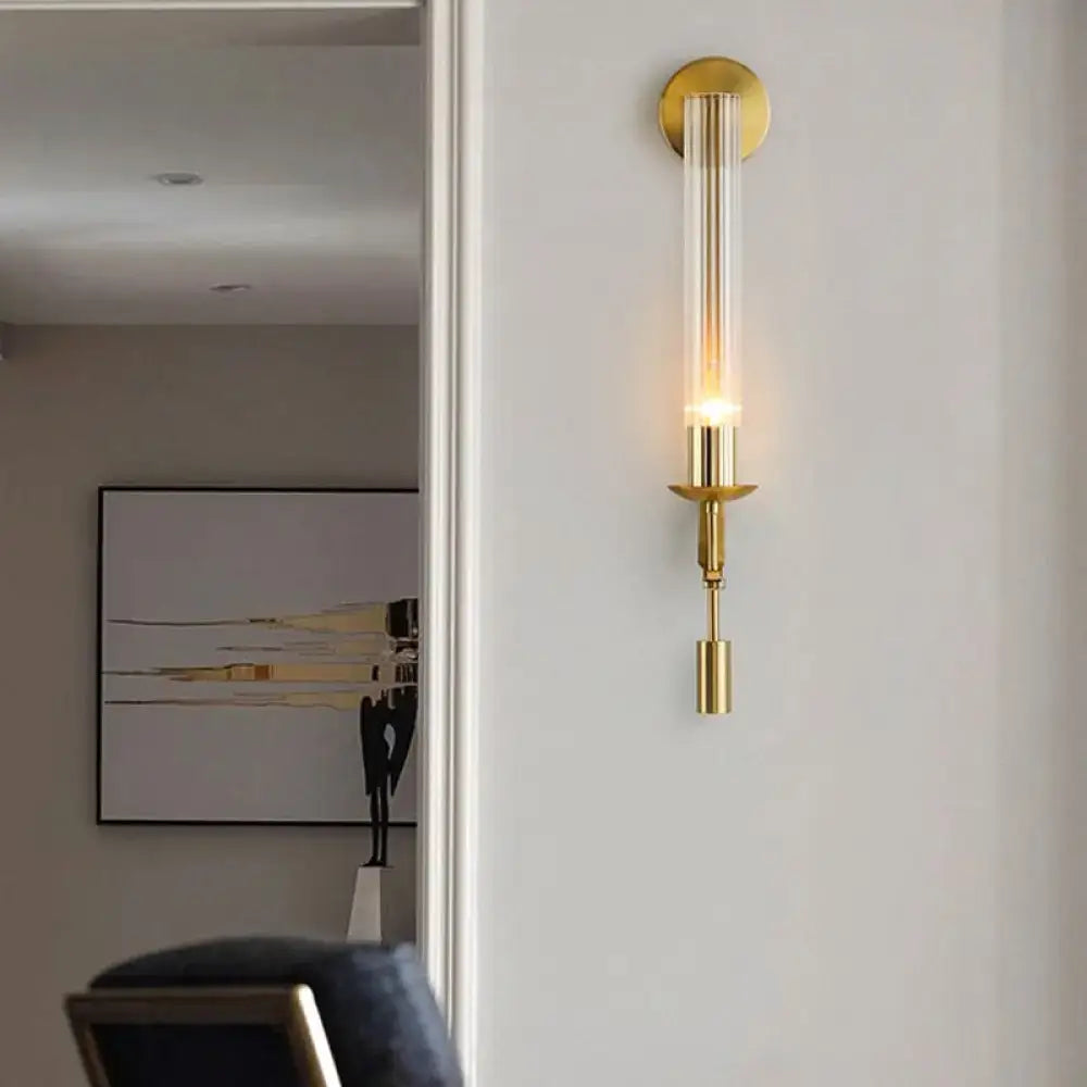 Modern gold wall sconce with clear glass shade bathroom light