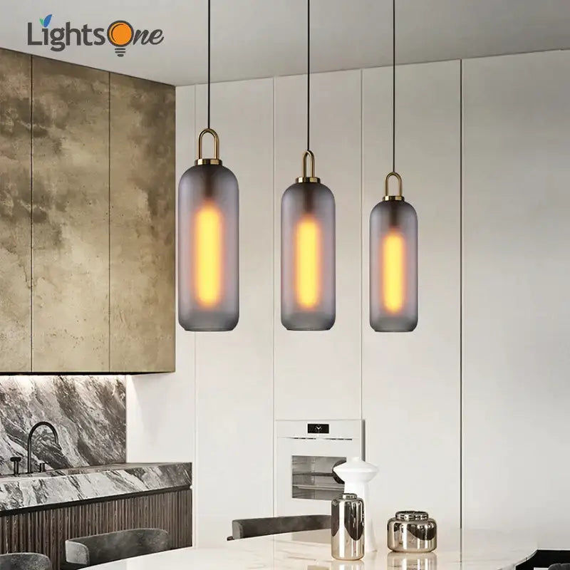 Modern gray glass ball pendant lights – dining room brass accents