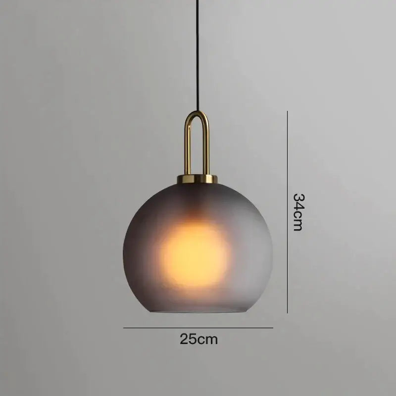 Modern gray glass ball pendant lights – dining room brass accents