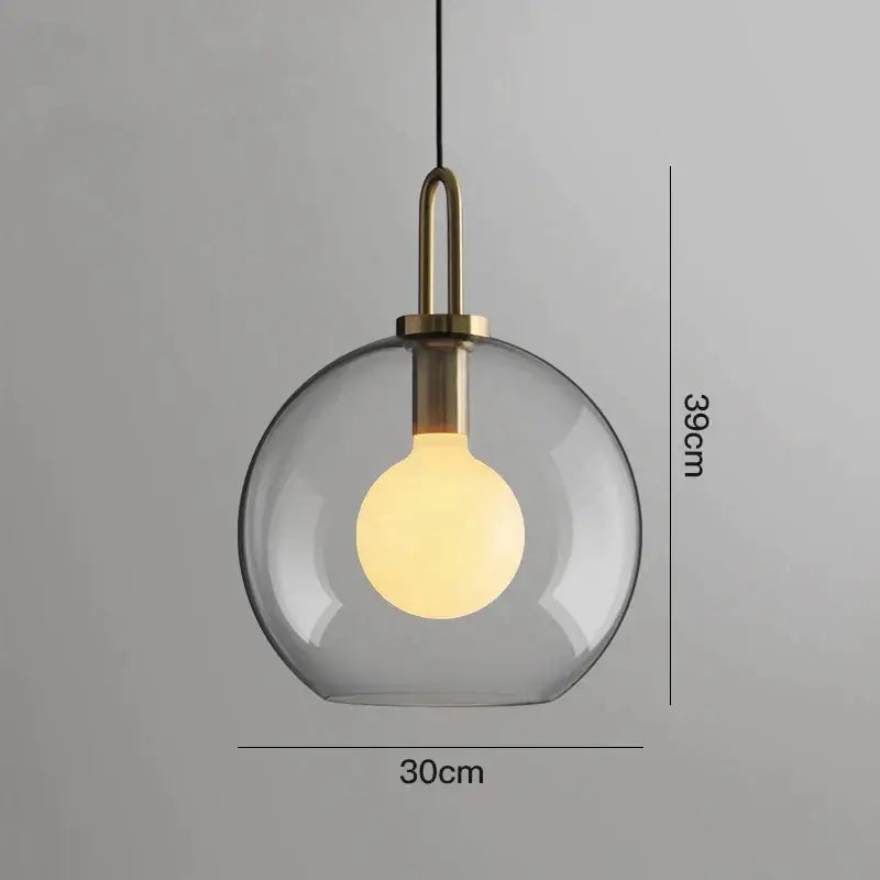 Modern gray glass ball pendant lights – dining room brass accents