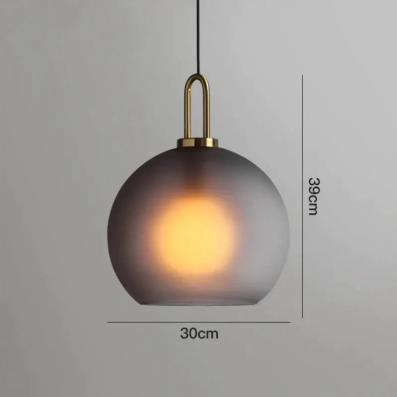 Modern gray glass ball pendant lights – dining room brass accents