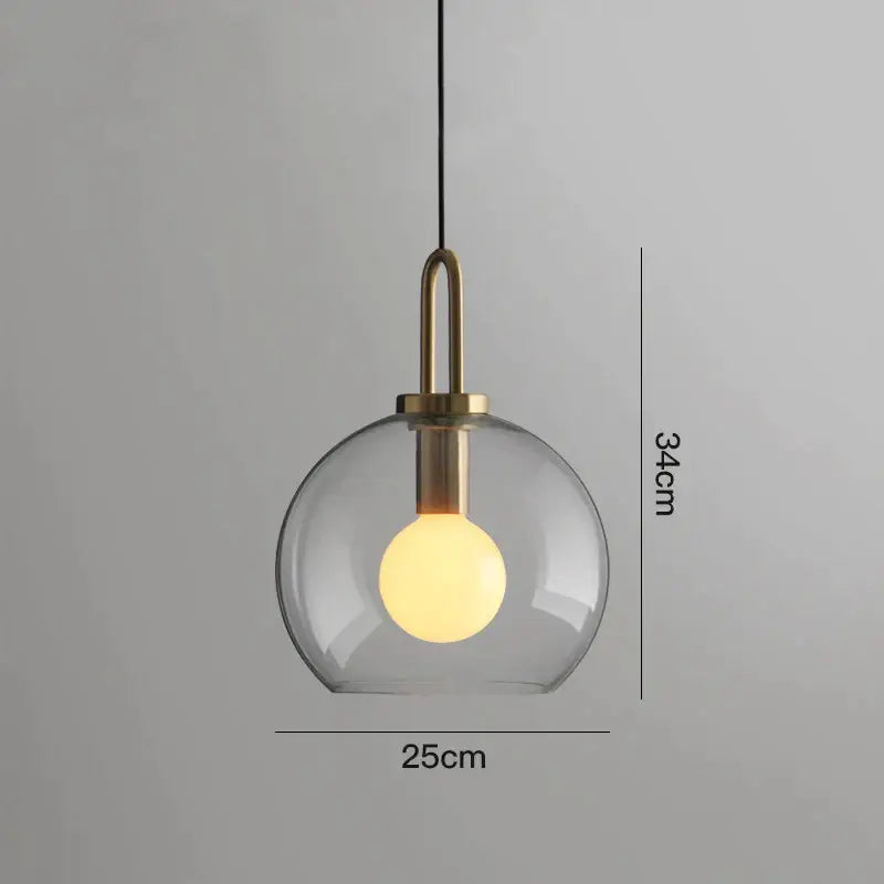 Modern gray glass ball pendant lights – dining room brass accents