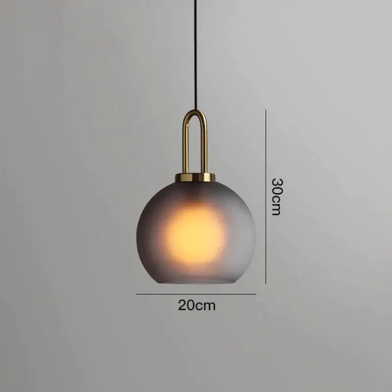 Modern gray glass ball pendant lights – dining room brass accents