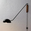 Modern matte black swing arm bedside wall lamp with wood accent bedroom