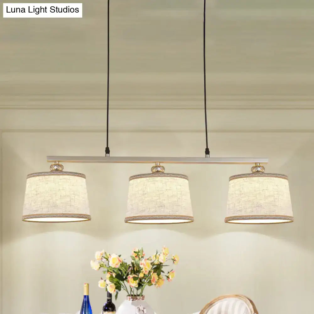 Modern silver and flaxen circle pendant light for kitchen island