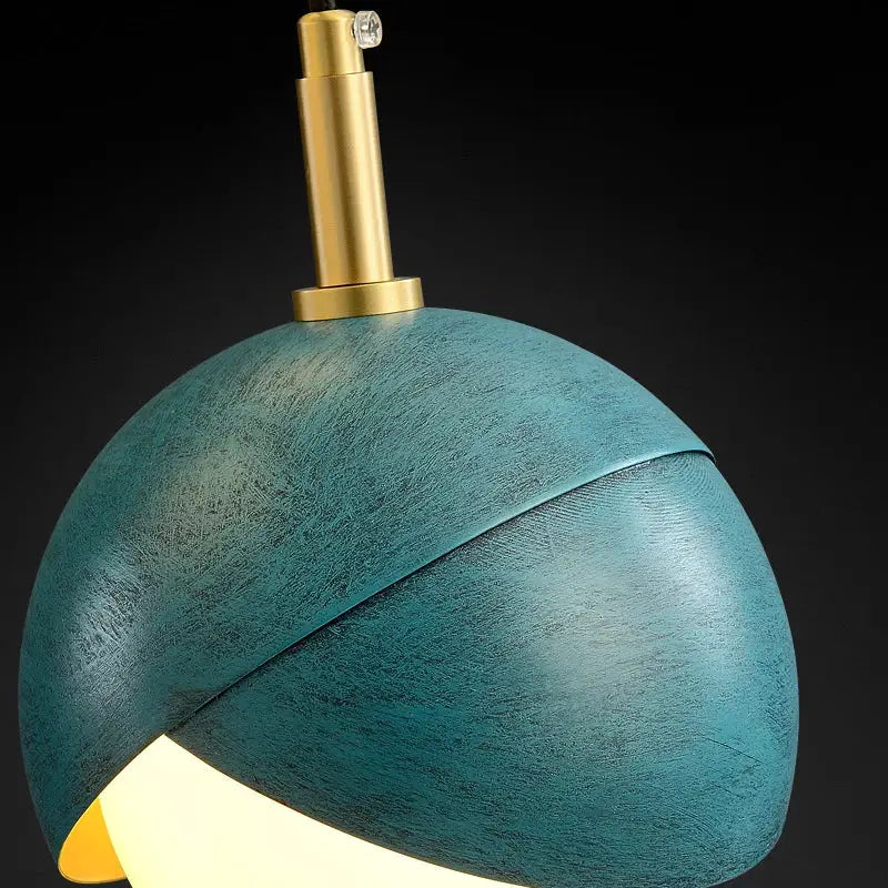 Modern teal glass and brass pendant light for kitchen island