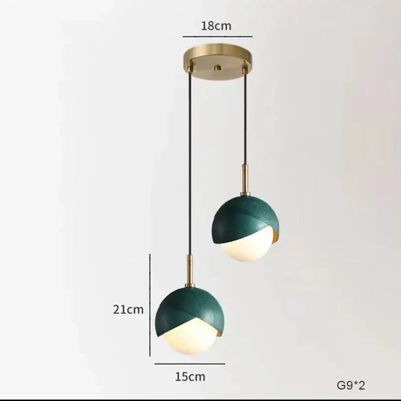 Modern teal glass and brass pendant light for kitchen island
