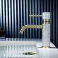 Modern white marble and brushed gold bathroom faucet with swivel spout