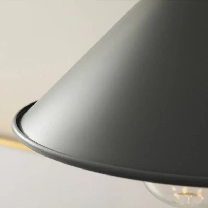 Modern yellow conical pendant light with copper knob for kitchens