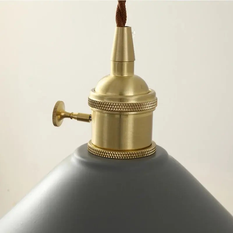 Modern yellow conical pendant light with copper knob for kitchens