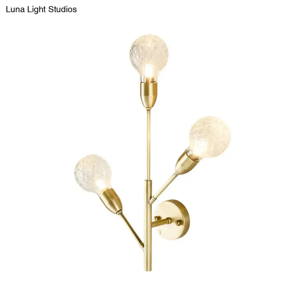 Modernist brass wall mount light fixture with prismatic glass bedroom