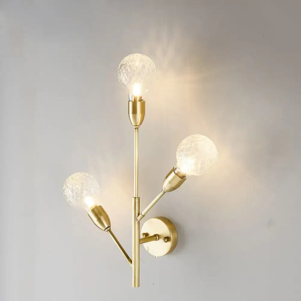 Modernist brass wall mount light fixture with prismatic glass bedroom