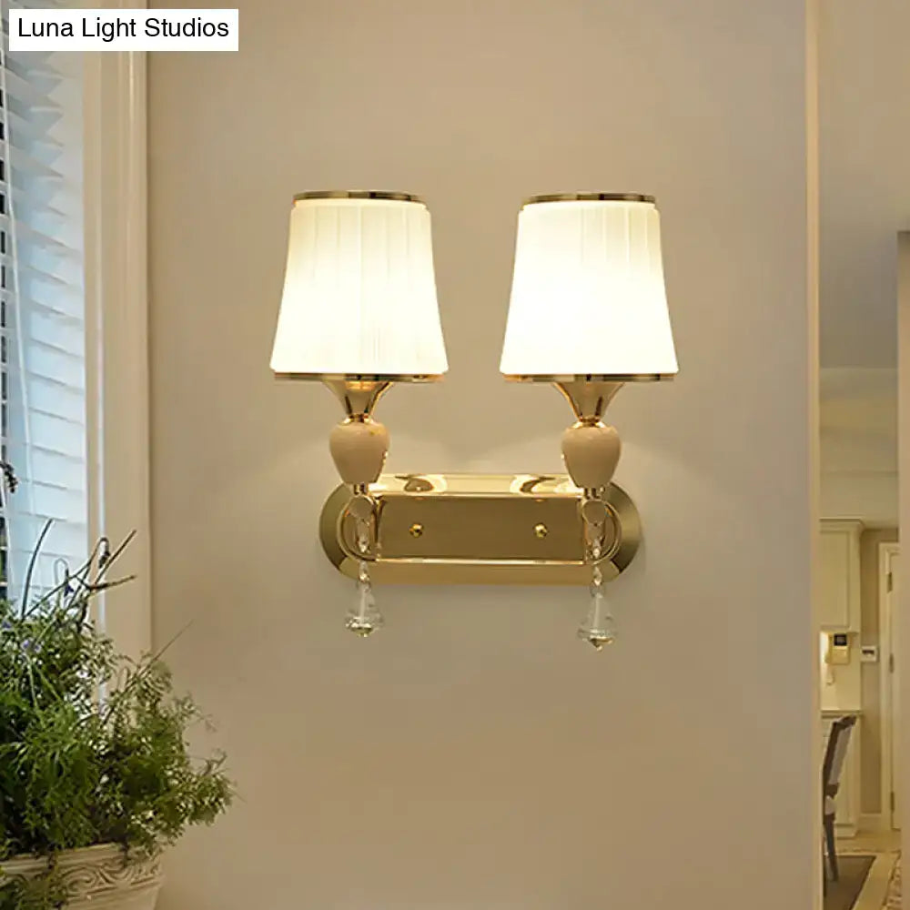 Modernist gold crystal wall sconce with pleated shades living room