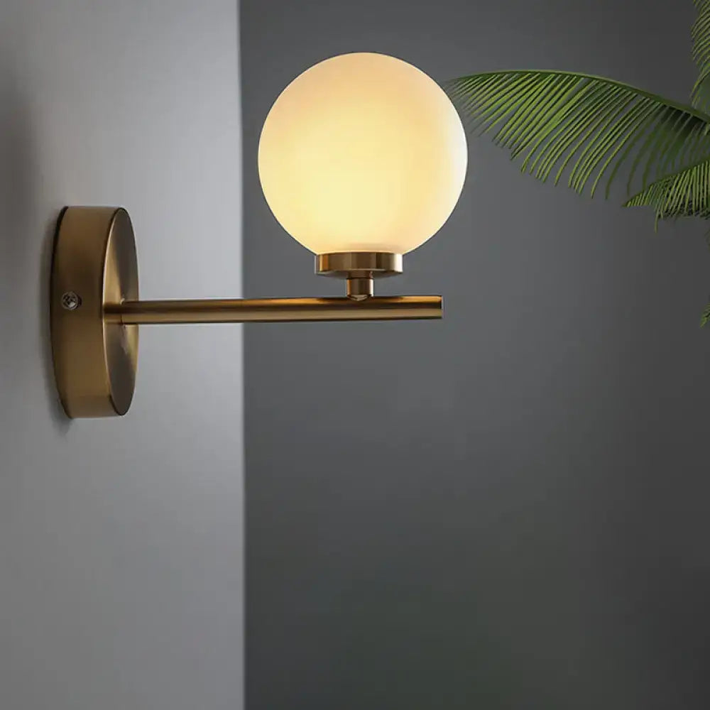 Nordic brass wall sconce light with glass globe – bedroom lighting