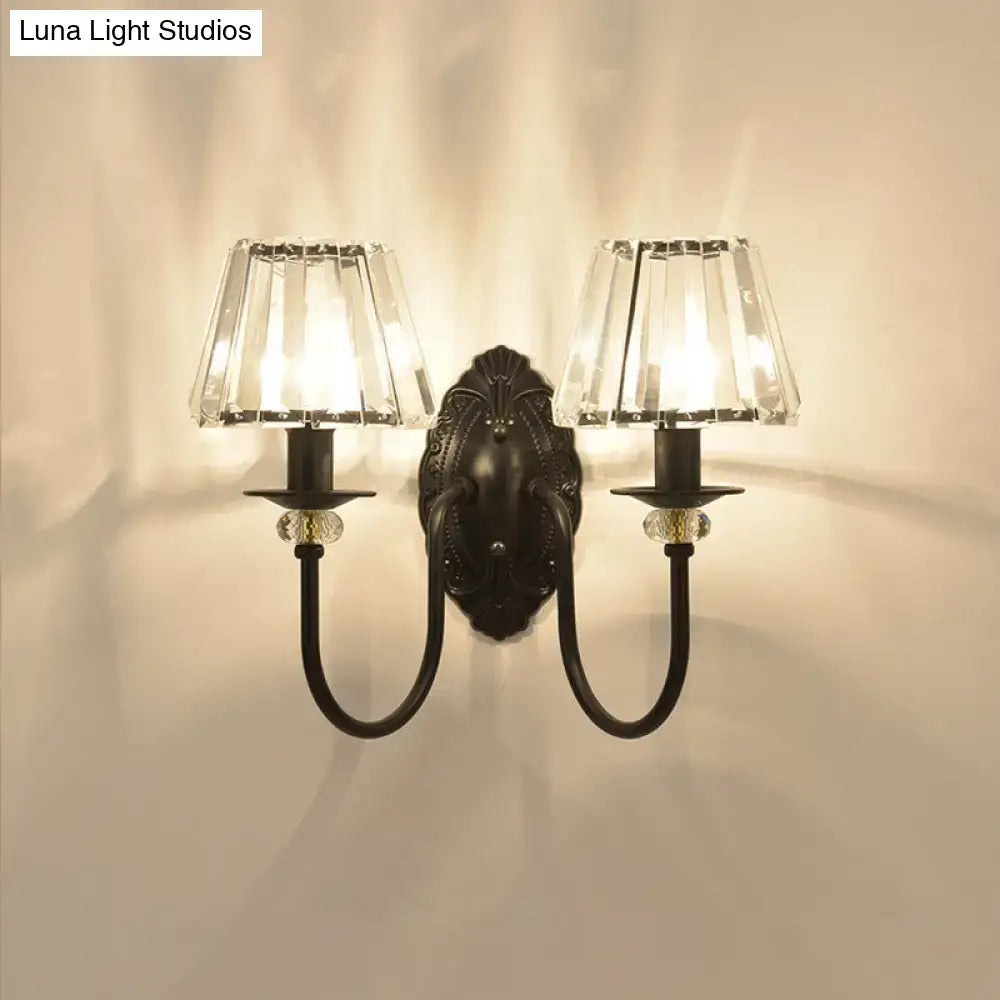Post-modern black metal wall sconce with clear crystal shade bedroom