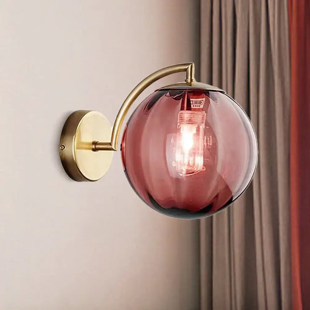 Postmodern brass armed ball sconce – bedroom amber glass wall light