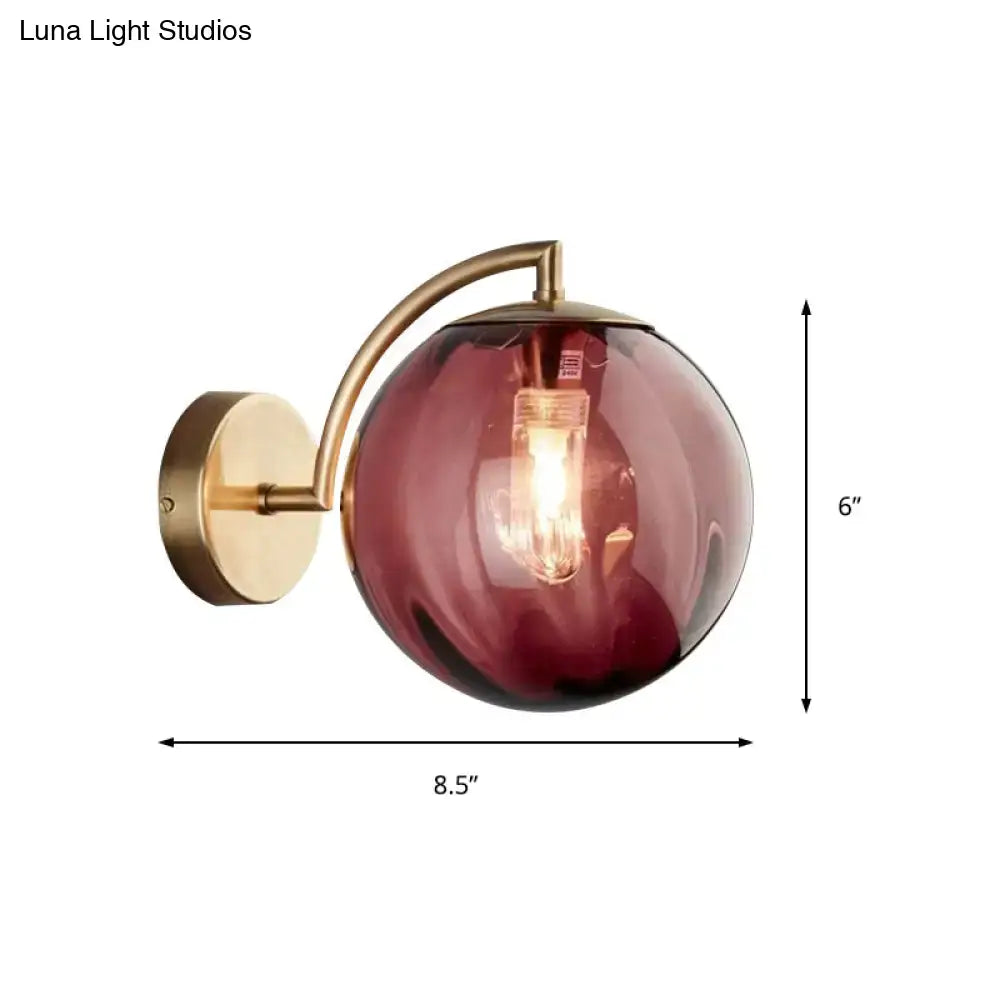 Postmodern brass armed ball sconce – bedroom amber glass wall light