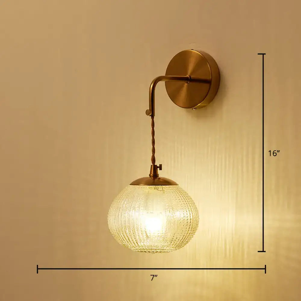 Postmodern gold ball shaped wall sconce with textured glass shade bedroom light