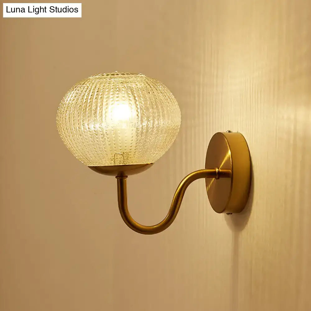 Postmodern gold ball shaped wall sconce with textured glass shade bedroom light