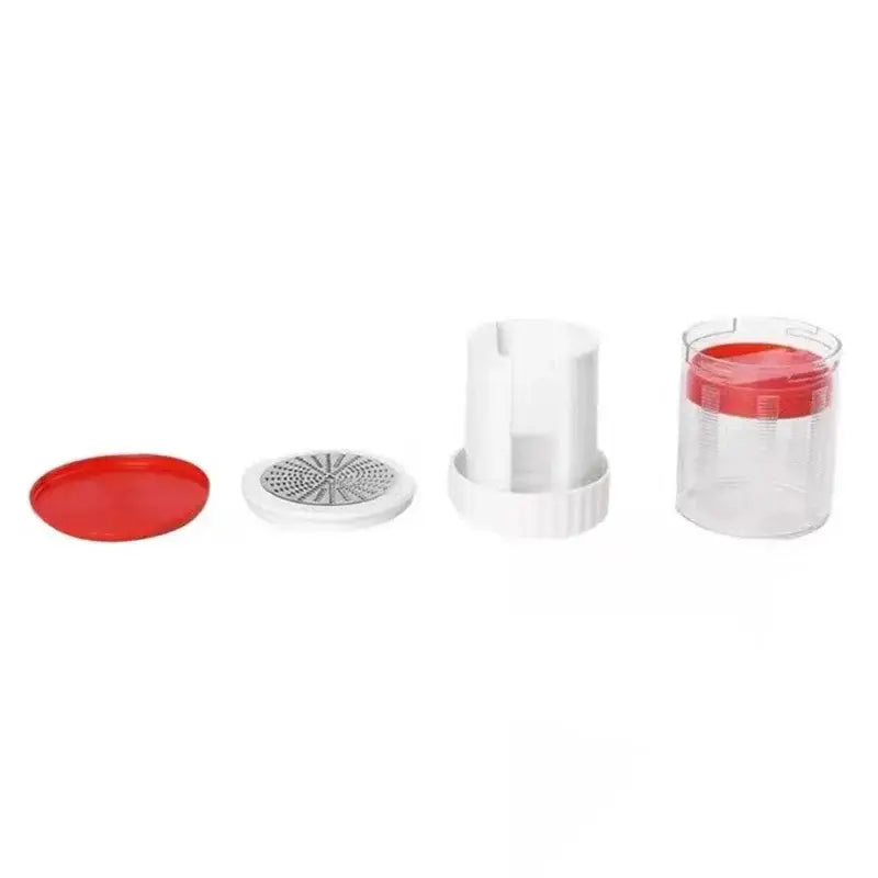 Red and white manual citrus juicer kitchen tool with measuring cup