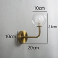 Retro brass curved wall lamp with clear glass ball for bedroom