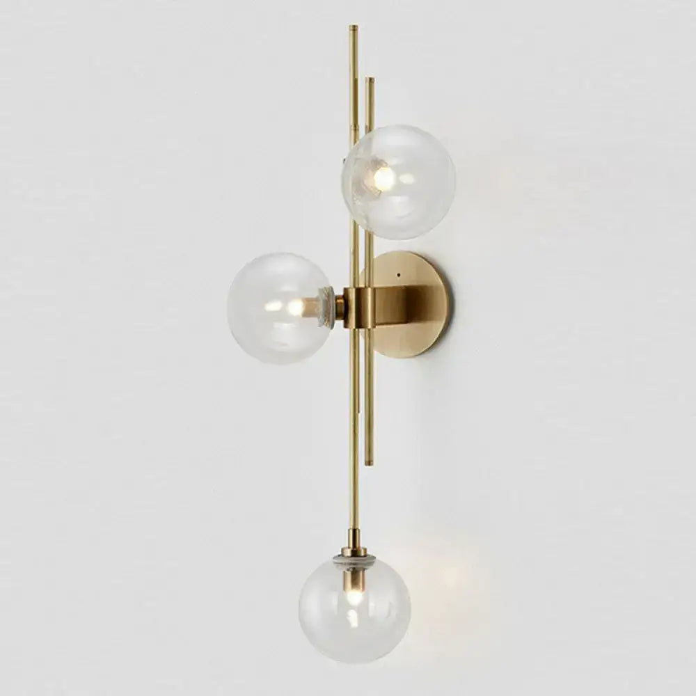 Retro brass wall sconce with 3 glass globes for dining room
