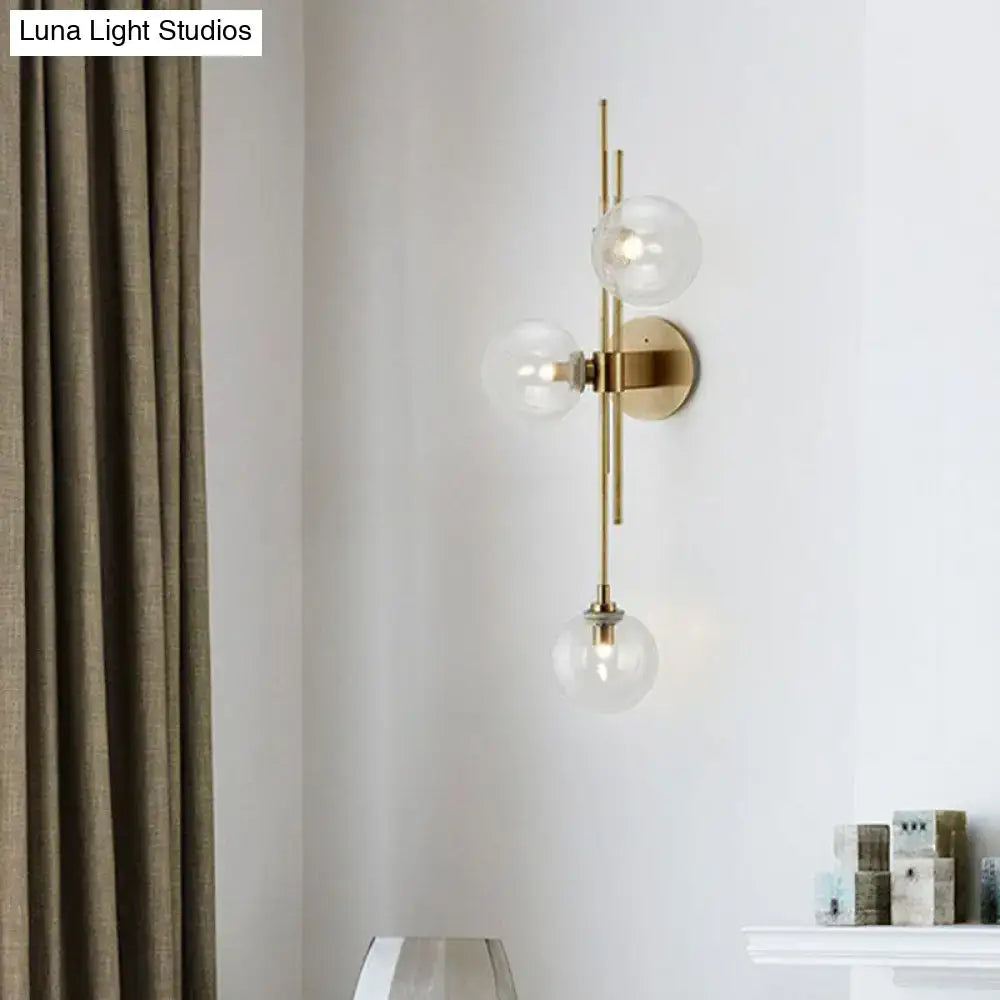 Retro brass wall sconce with 3 glass globes for dining room