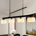 Traditional black drum island pendant with white shades dining room