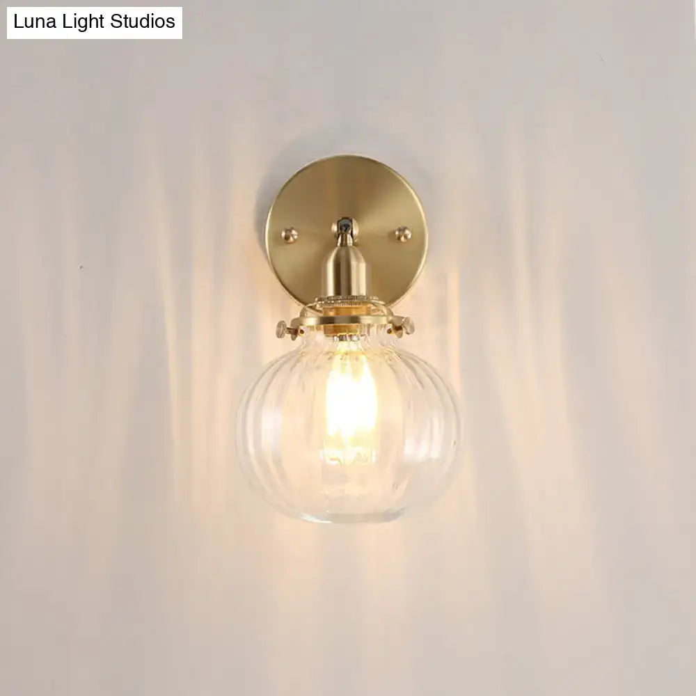 Vintage brass wall light with champagne & clear glass shade bedroom
