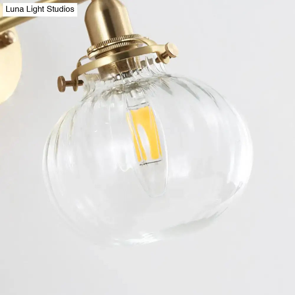 Vintage brass wall light with champagne & clear glass shade bedroom